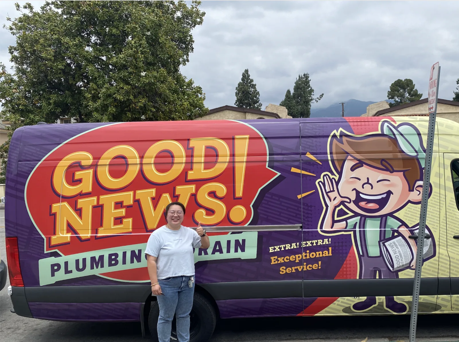 A Good News team member with our wrapped service van